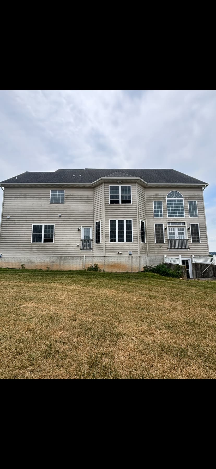 Two-story vinyl siding soft wash — before