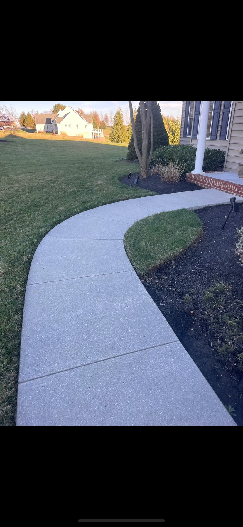 Curved concrete walkway pressure wash — after